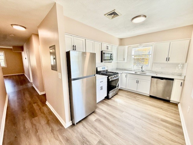 a kitchen with white cabinets and white appliances