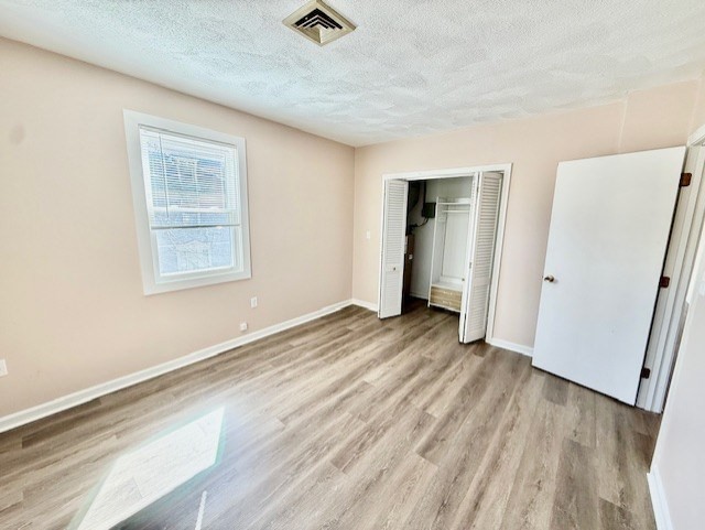 400 Massachusetts Avenue, Unit 4 Arlington, MA 02474 - Photo 12 of 20 an empty room with wooden floor and windows