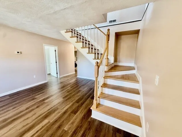 a view of entryway and hall with wooden floor