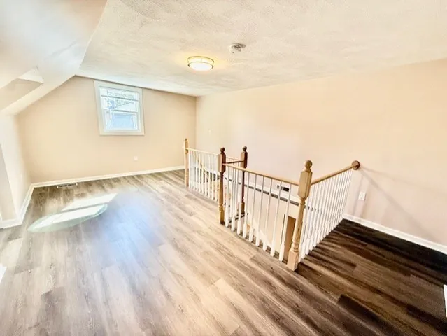 a view of wooden floor in an empty room