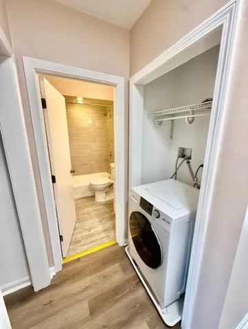 a view of storage and utility room with washer and dryer