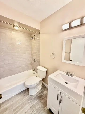 a bathroom with a double vanity sink toilet and shower