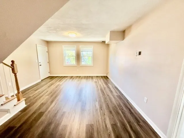 a view of a room with wooden floor and a window