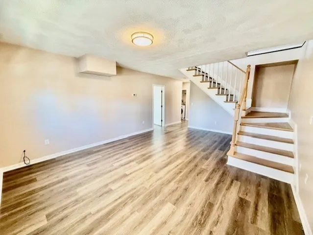 a view of a room with wooden floor and stairs