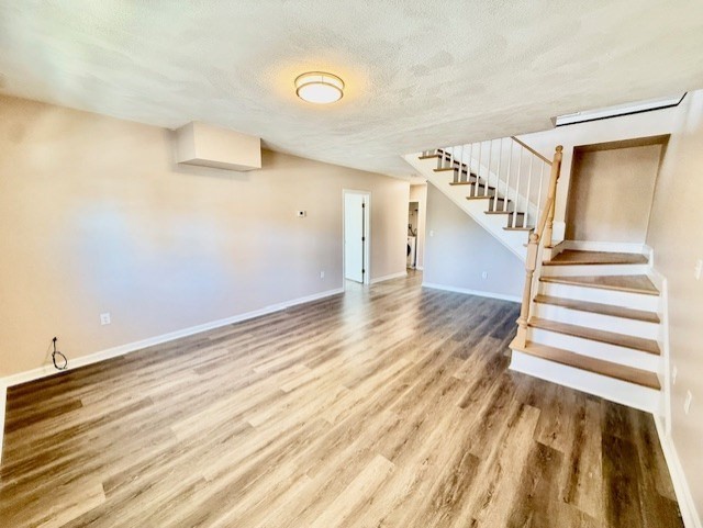 400 Massachusetts Avenue, Unit 4 Arlington, MA 02474 - Photo 9 of 20 a view of a room with wooden floor and stairs