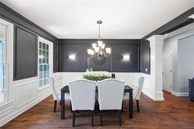 a living room with furniture a wooden floor and a chandelier