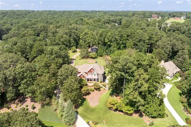 a living room with furniture a floor to ceiling window and a flat screen tv