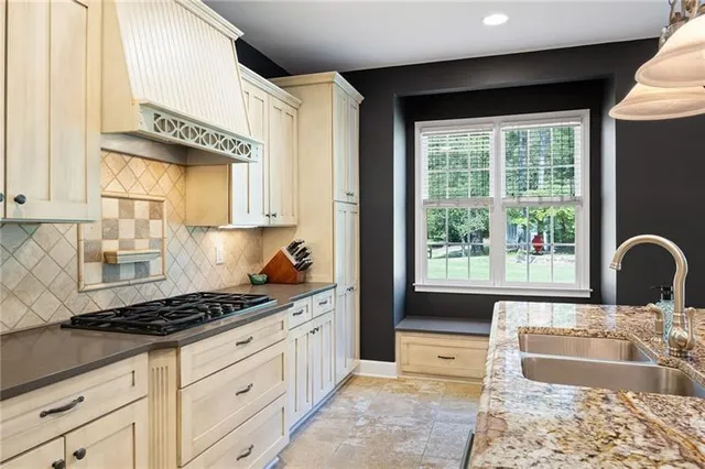 a work room with furniture a rug and a window
