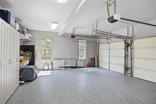 a bedroom with a bed and flat tv screen on the dresser