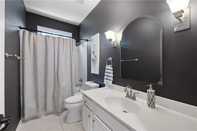 a bathroom with a sink toilet vanity and shower