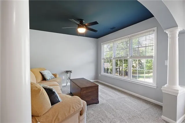 a room with table chairs and a ceiling fan