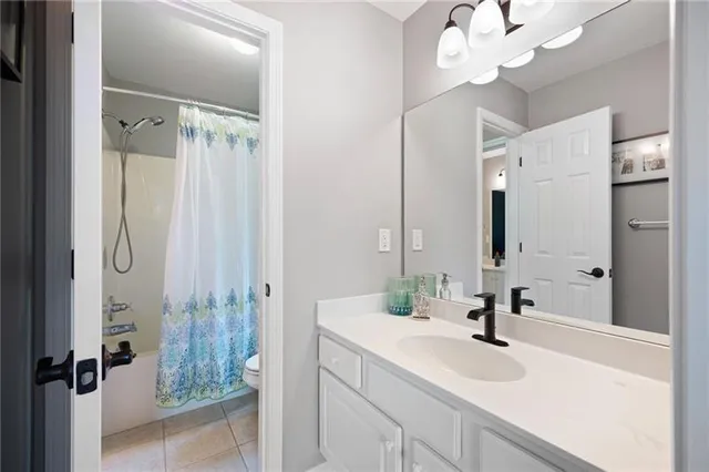 a aerial view of a house with a yard and large trees