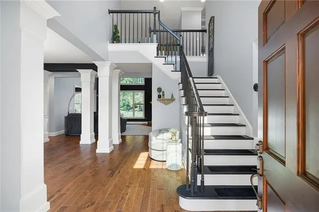 a dining room with furniture a chandelier and wooden floor