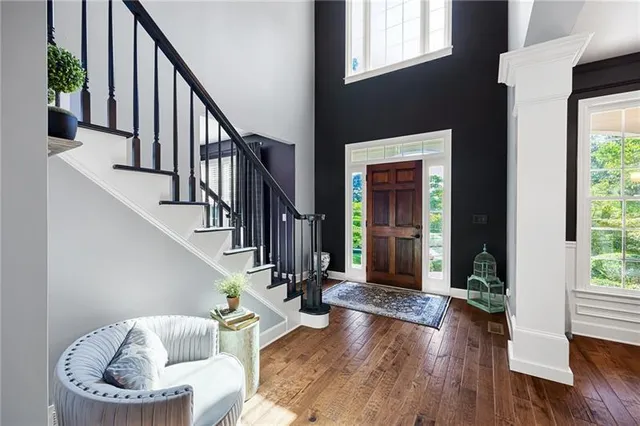 a bed sitting in a bedroom next to a window and a chandelier