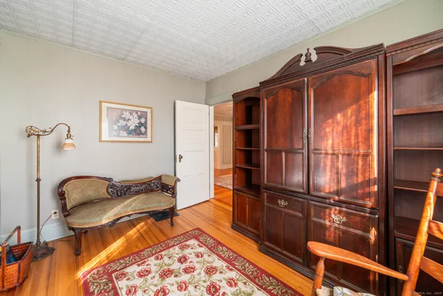 a bedroom with furniture and a rug