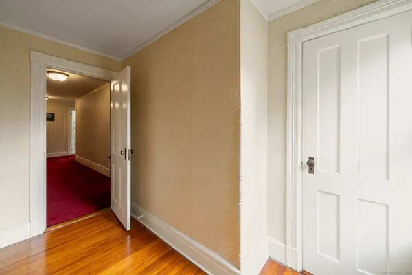 a view of a hallway with wooden floor