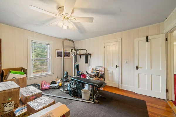 a bedroom with furniture toys ceiling fan and a window