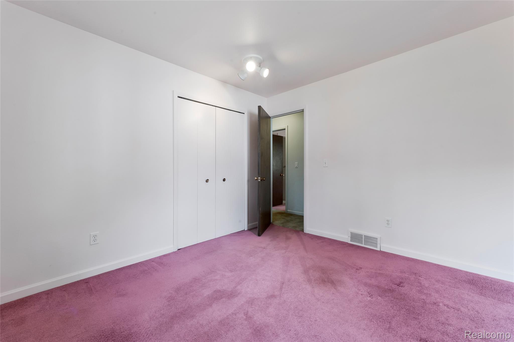 8887 Clark Road Clarkston, MI 48346 - Photo 21 of 40 Unfurnished bedroom featuring carpet and a closet