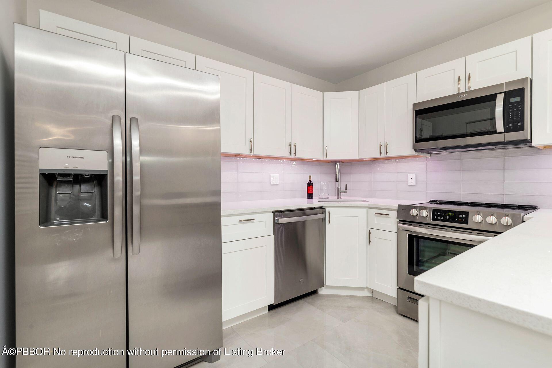a kitchen with cabinets stainless steel appliances and a counter top