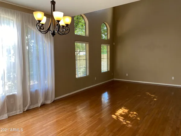 a view of a hallway with entryway wooden floor and front door