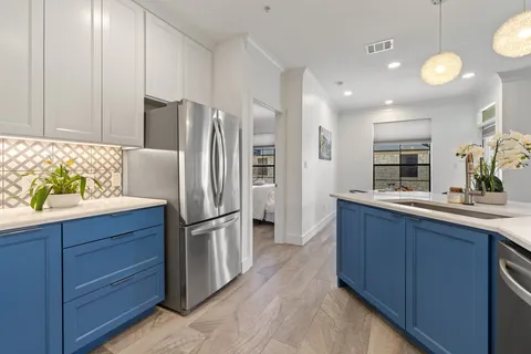 a kitchen with a refrigerator and a sink