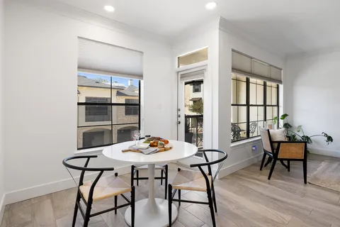 a view of a dining room with furniture and window