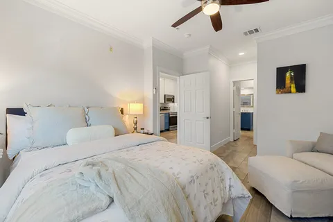 a spacious bedroom with a bed and a couch