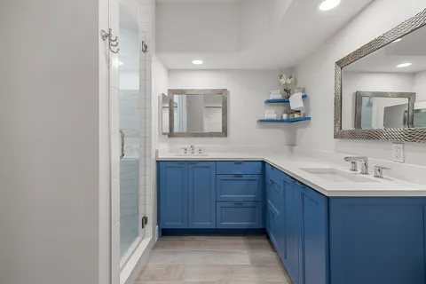 a bathroom with a granite countertop sink mirror and double