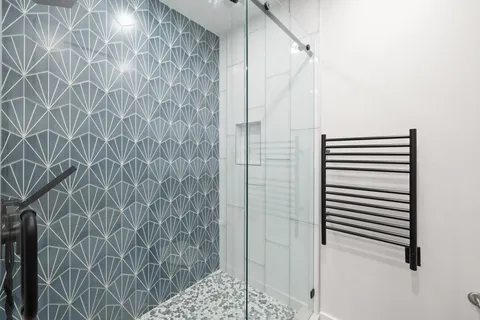 a bathroom with a shower and a sink