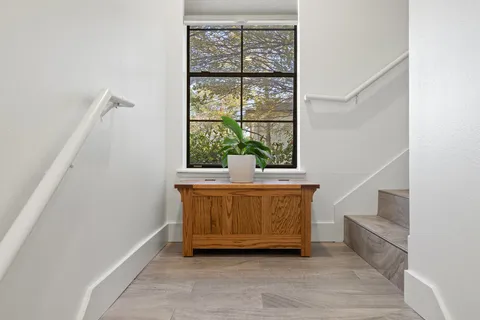 a view of room with window and wooden floor