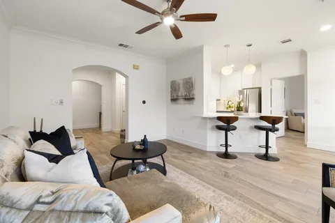 a living room with furniture and a wooden floor