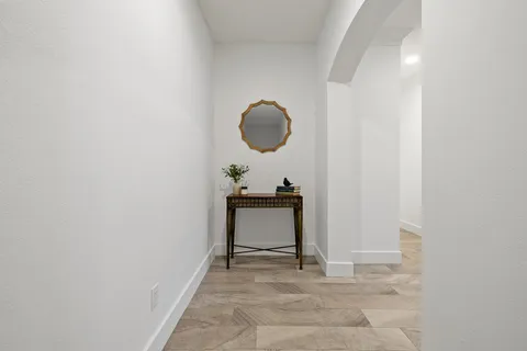 a view of a room with a bench and mirror