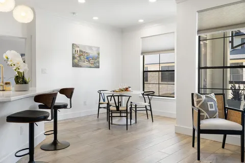 a view of a livingroom with furniture and a potted plant