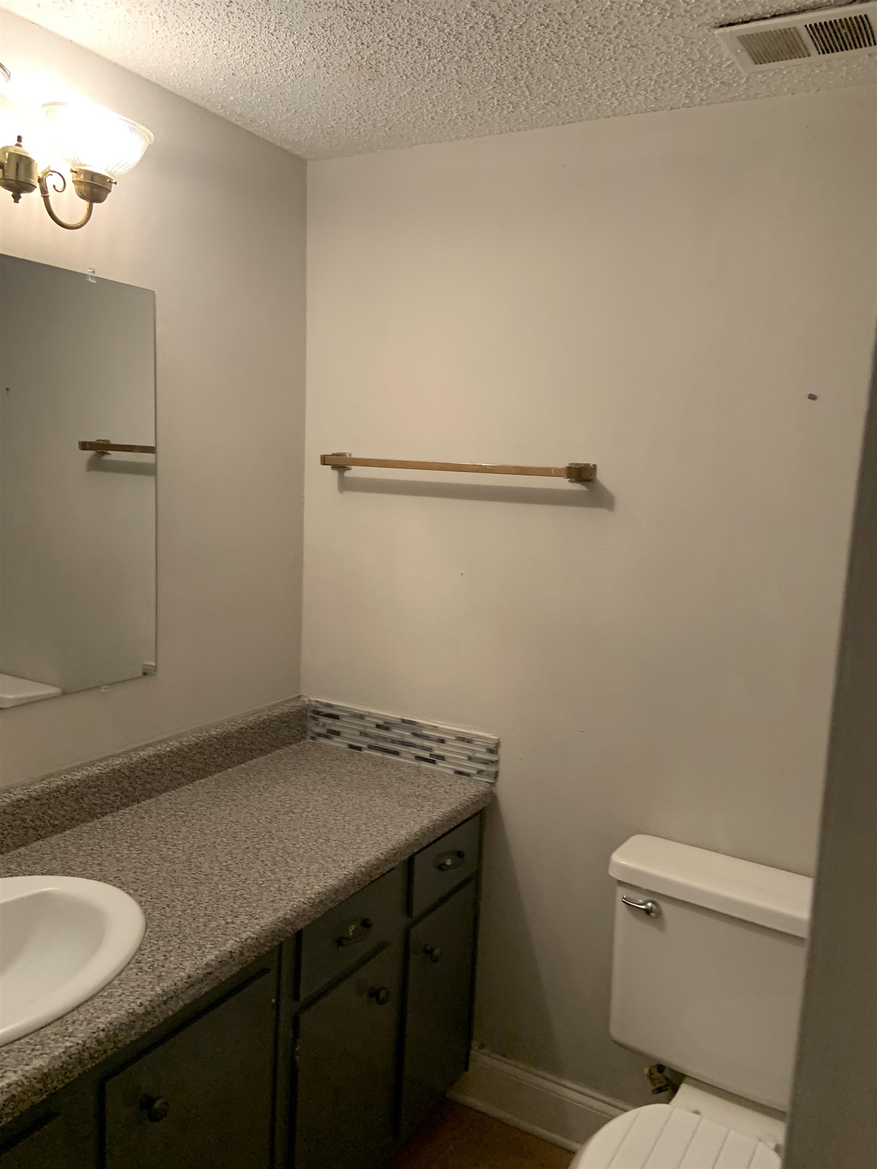 5588 Clarke Address, Unit 51 Memphis, TN 38115 - Photo 1 of 13 a bathroom with a granite countertop sink and a toilet