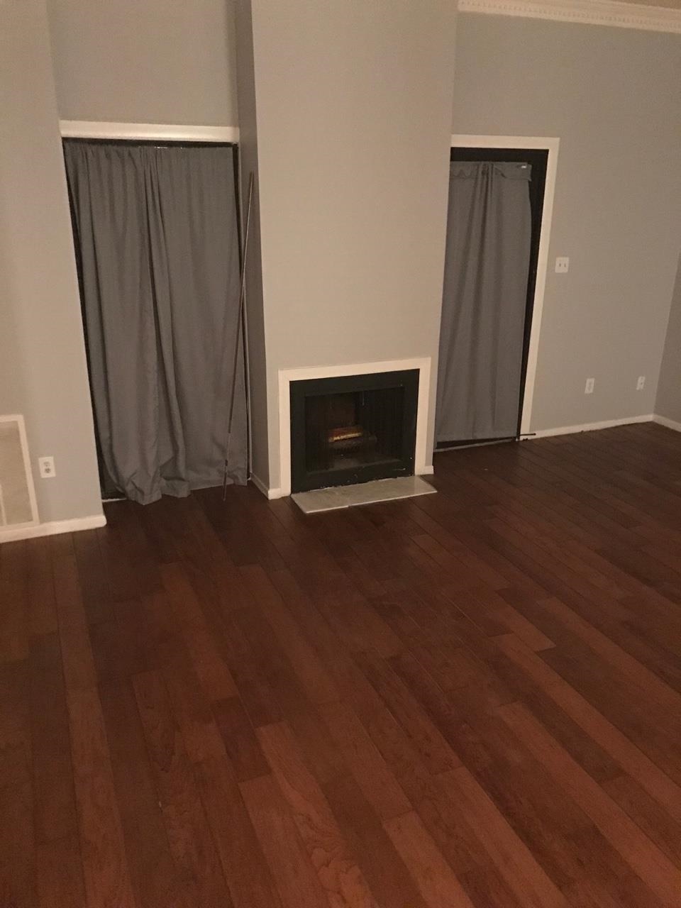 5588 Clarke Address, Unit 51 Memphis, TN 38115 - Photo 12 of 13 a view of an empty room with wooden floor and a window