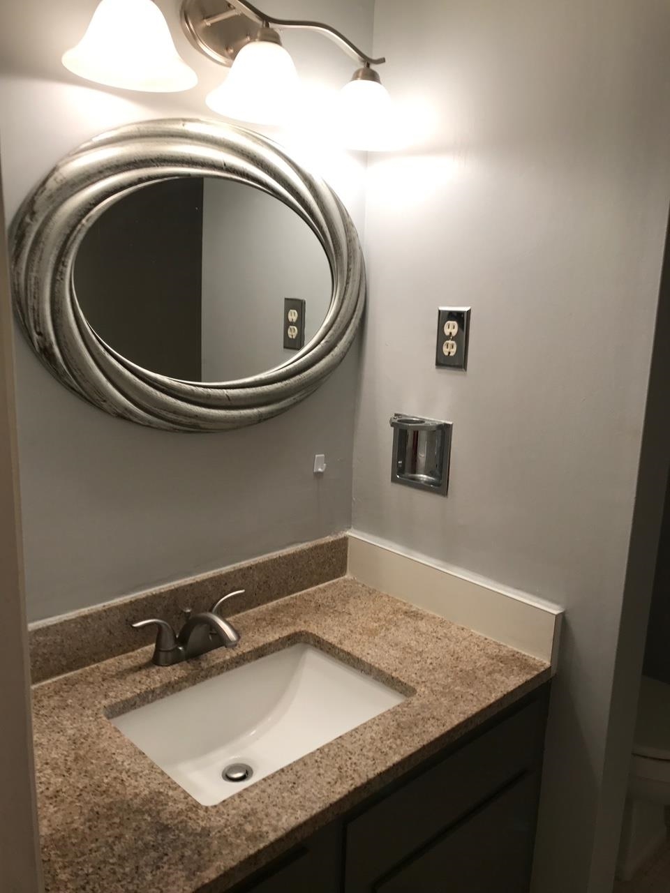 5588 Clarke Address, Unit 51 Memphis, TN 38115 - Photo 4 of 13 a bathroom with a granite countertop sink and a toilet