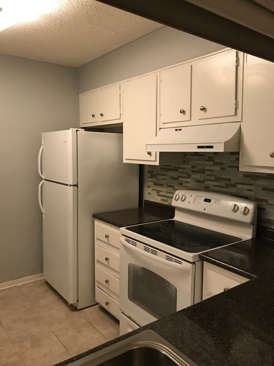 5588 Clarke Address, Unit 51 Memphis, TN 38115 - Photo 9 of 13 a kitchen with appliances and cabinets