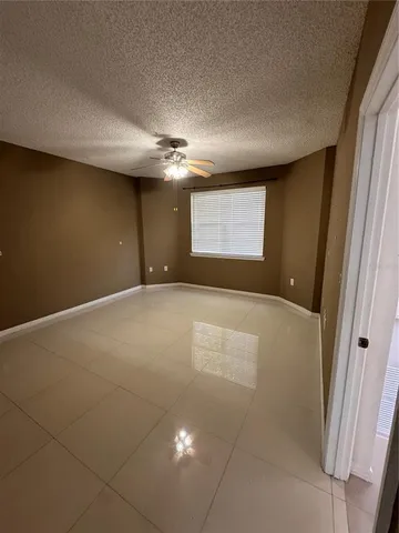 an empty room with windows and entrance