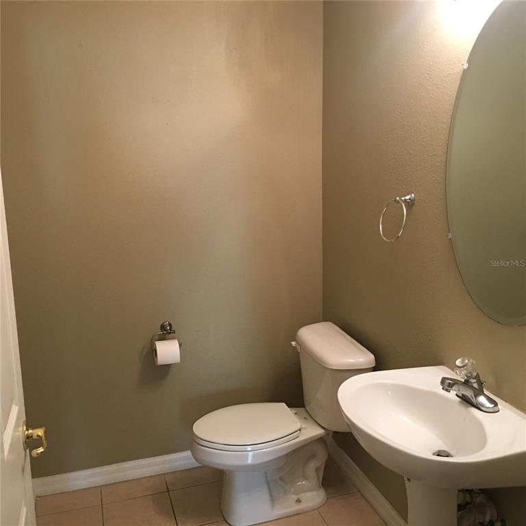 18047 Java Isle Drive Tampa, FL 33647 - Photo 13 of 21 a bathroom with a toilet sink and mirror