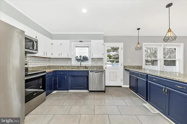 a kitchen with a sink stove and microwave
