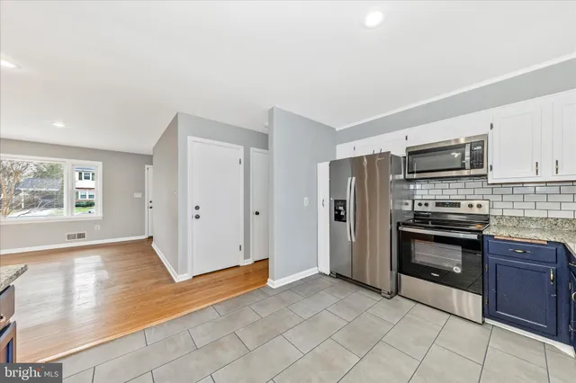 a view of a livingroom with wooden floor and a ceiling fan