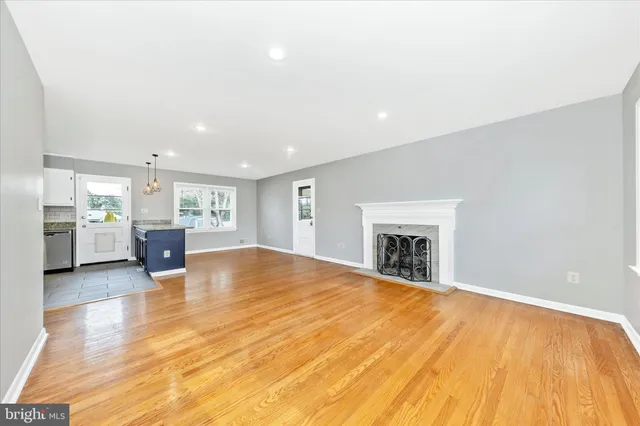 a view of kitchen and kitchen with furniture and wooden floor
