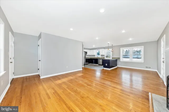 a view of an empty room with a window and fireplace