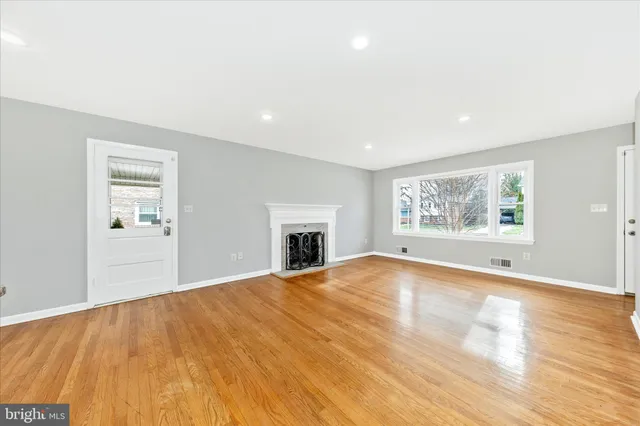 a view of kitchen with stainless steel appliances granite countertop cabinets and wooden floor