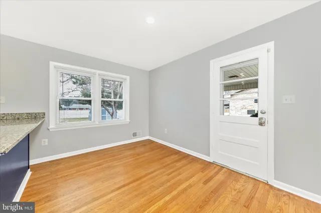 a large kitchen with stainless steel appliances granite countertop a stove sink and cabinets