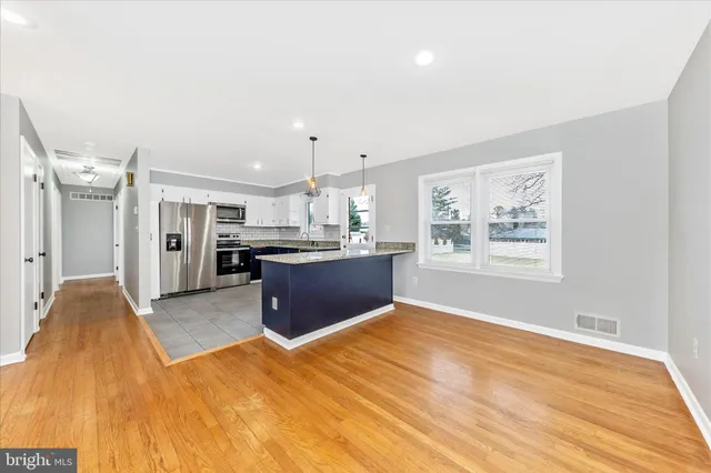 a large kitchen with granite countertop a sink and dishwasher