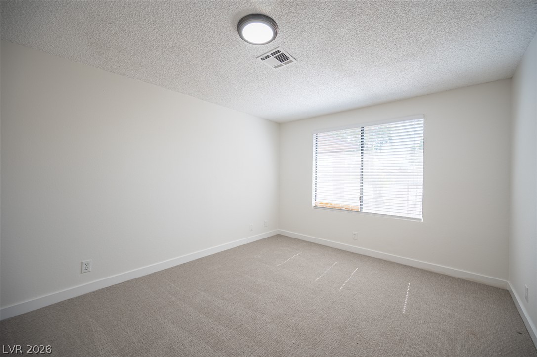 7041 North Decatur Boulevard Las Vegas, NV 89131 - Photo 23 of 33 A well-proportioned bedroom offers new carpeting and a sun-filled window.
