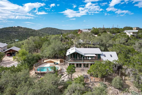 an aerial view of a house with yard and mountain view in back