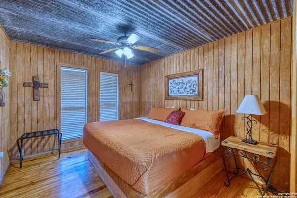 a bedroom with bed and a chandelier