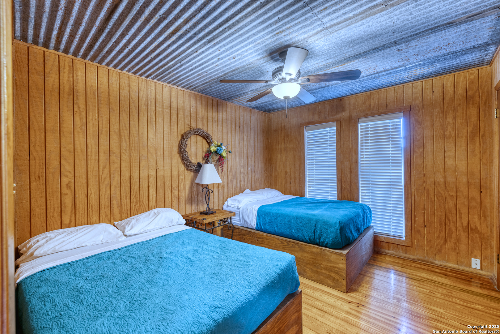 186 Cat Claw Mountain Road Concan, TX 78838 - Photo 12 of 31 a bedroom with bed and a chandelier